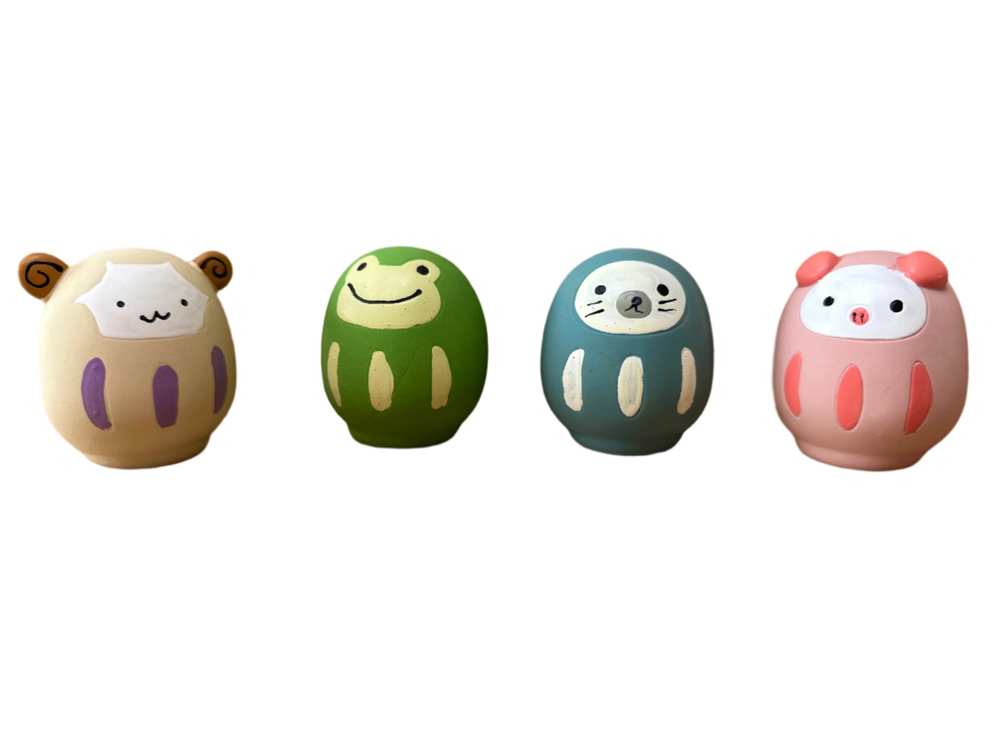Four colorful animal-shaped objects on a wooden surface with a wooden background