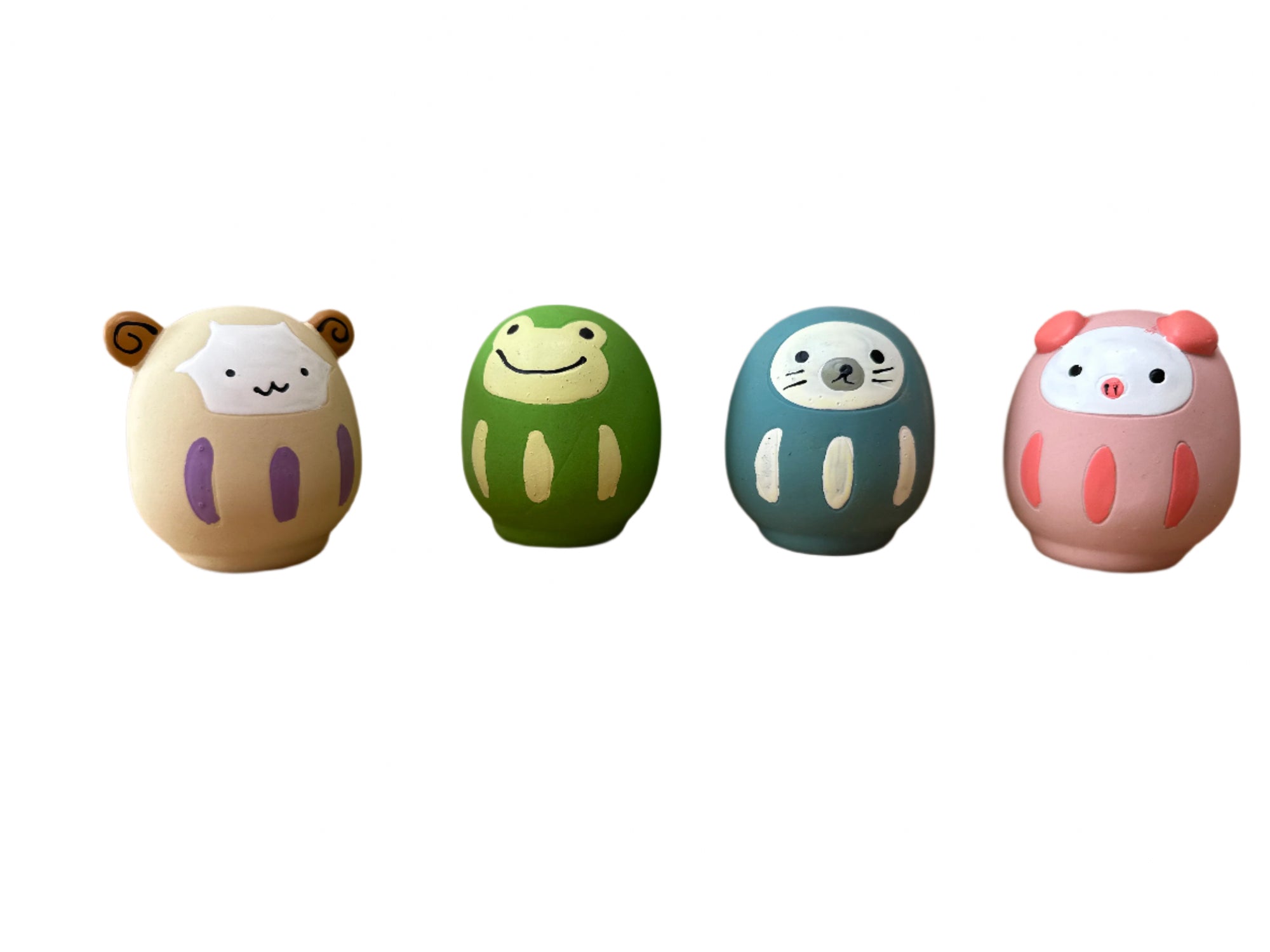 Four colorful rubber animals on a wooden surface