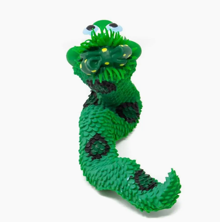 Green snake-shaped toy with black patterns on a white background