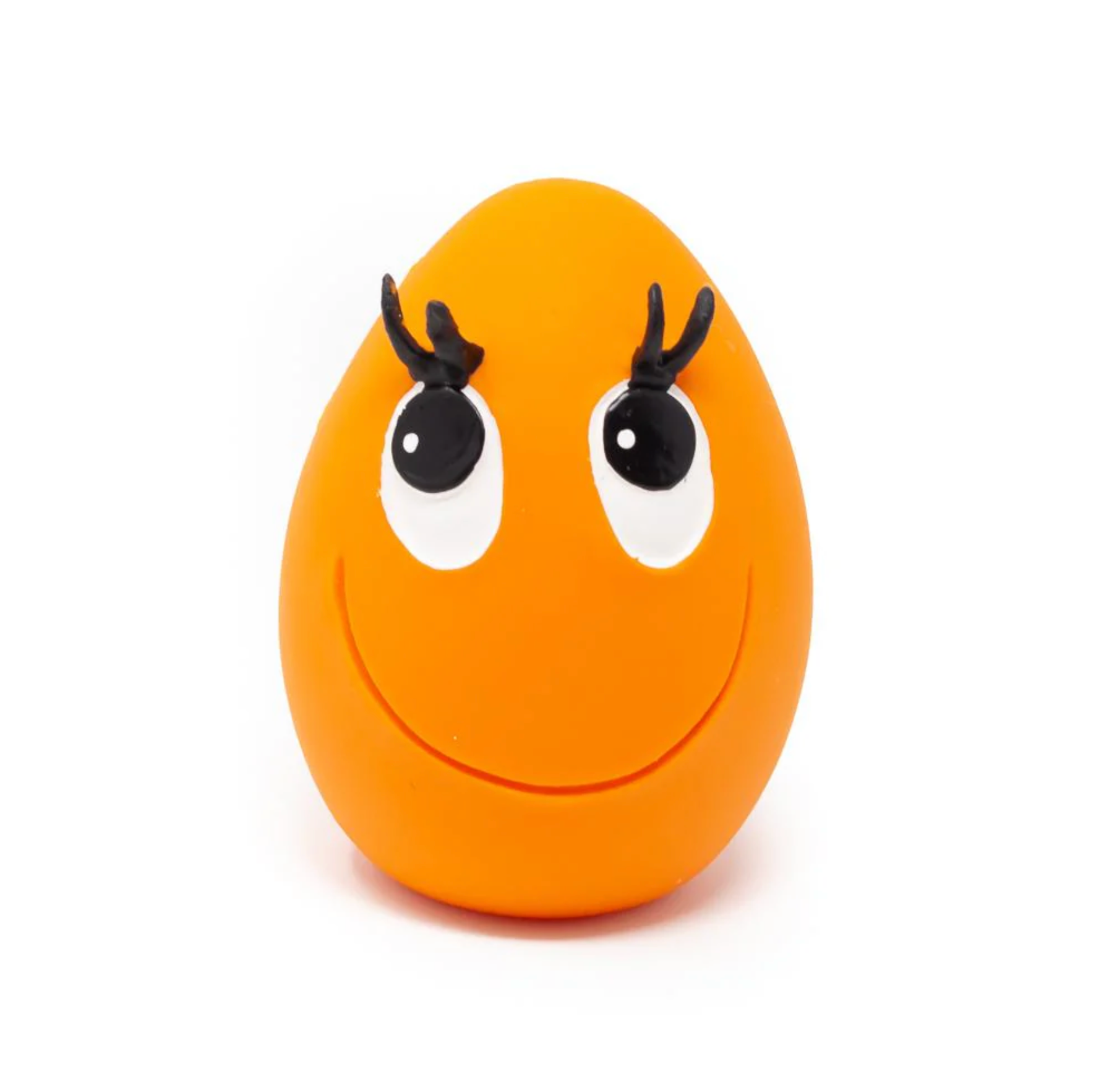 An orange egg-shaped dog toy with a smiling face and eyes painted in black and white.