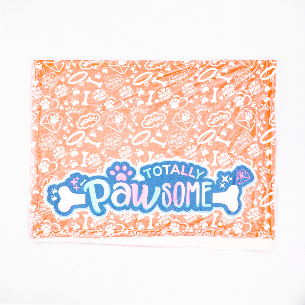 Blanket with 'Totally Pawsome' text and paw prints on a white background
