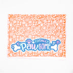 Blanket with 'Totally Pawsome' text and paw prints on a white background