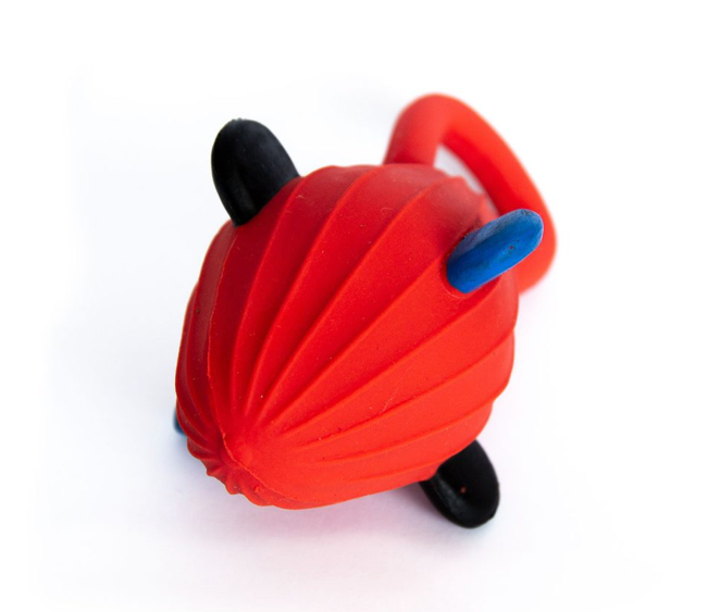 Red toy with black wheels and blue accents on a white background