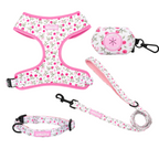 Floral pet harness, leash, and pouch set on a white background