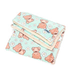 Folded blanket with teddy bear pattern on a light blue background