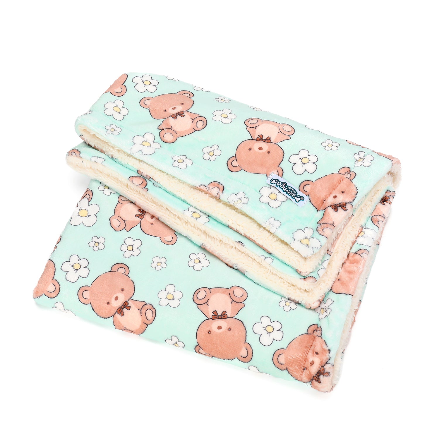 Folded blanket with teddy bear pattern on a light blue background