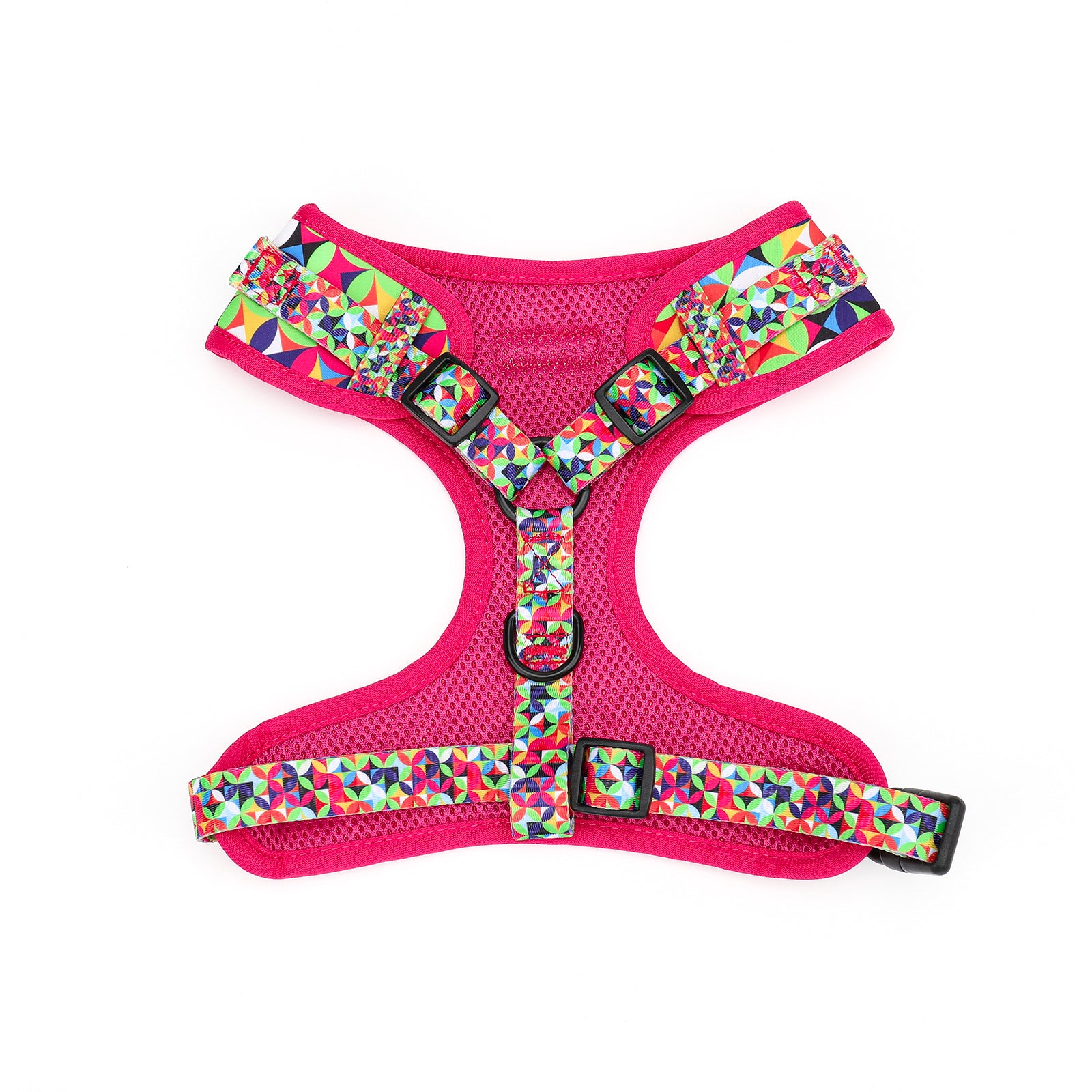 Pink dog harness with colorful geometric pattern on a white background