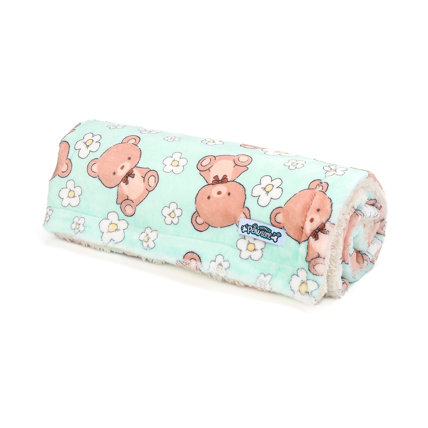Rolled-up dog blanket with teddy bear and flower pattern on a white background