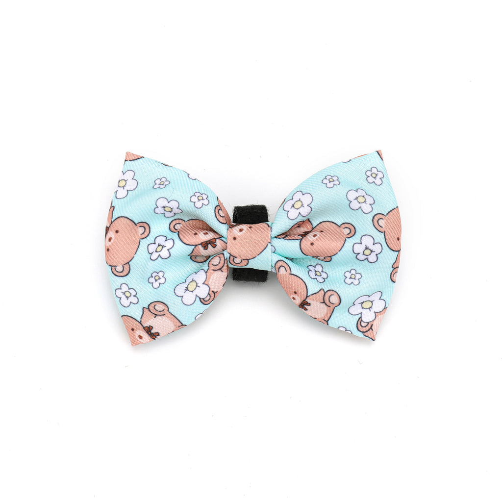 Dog bow tie with teddy bear and flower pattern on a light blue background