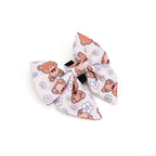 Bow tie with teddy bear and flower pattern on a white background