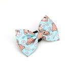 Dog bow tie with teddy bear and flower pattern on a light blue background