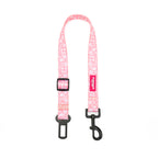 Pink floral patterned dog seatbelt with black clips on a white background