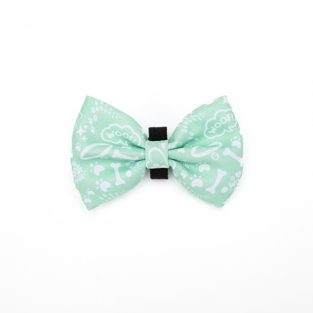 Green bow tie with white patterns on a white background