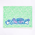 blanket with 'Totally Pawsome' text and paw prints on a green background