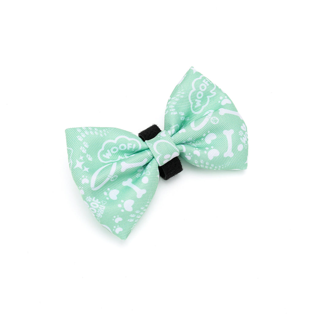 Green bow tie with white patterns on a white background