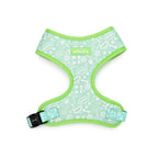Dog harness with green border and white pattern on a white background