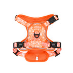 Orange dog harness with white paw print pattern on a white background