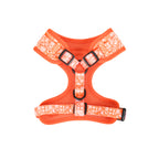 Orange dog harness with white pattern on a white background