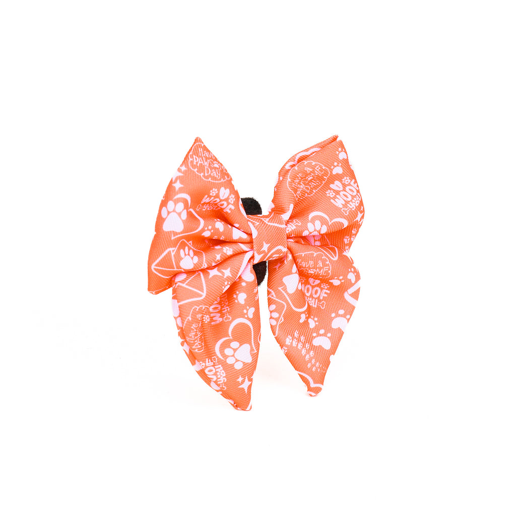 Large orange bow with white patterns on a white background