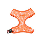 Orange dog harness with white patterns on a white background