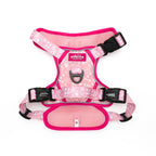 Pink dog harness with bone pattern on a white background