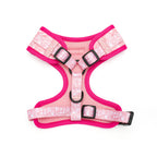 Pink dog harness with floral pattern on a white background