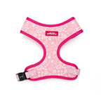 Pink dog harness with white patterns on a white background