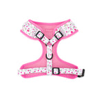 Pink dog harness with floral pattern on a white background