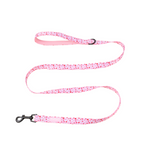 Pink dog leash with red heart pattern on a white background