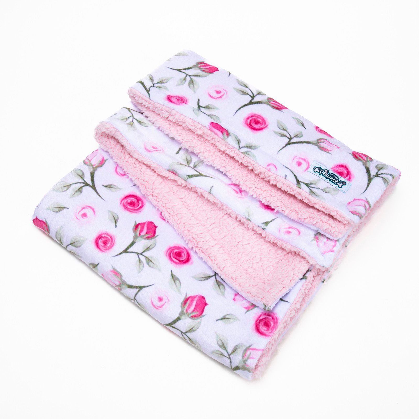 Floral patterned blanket with pink edges on a white background