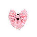Pink bow with white patterns on a white background