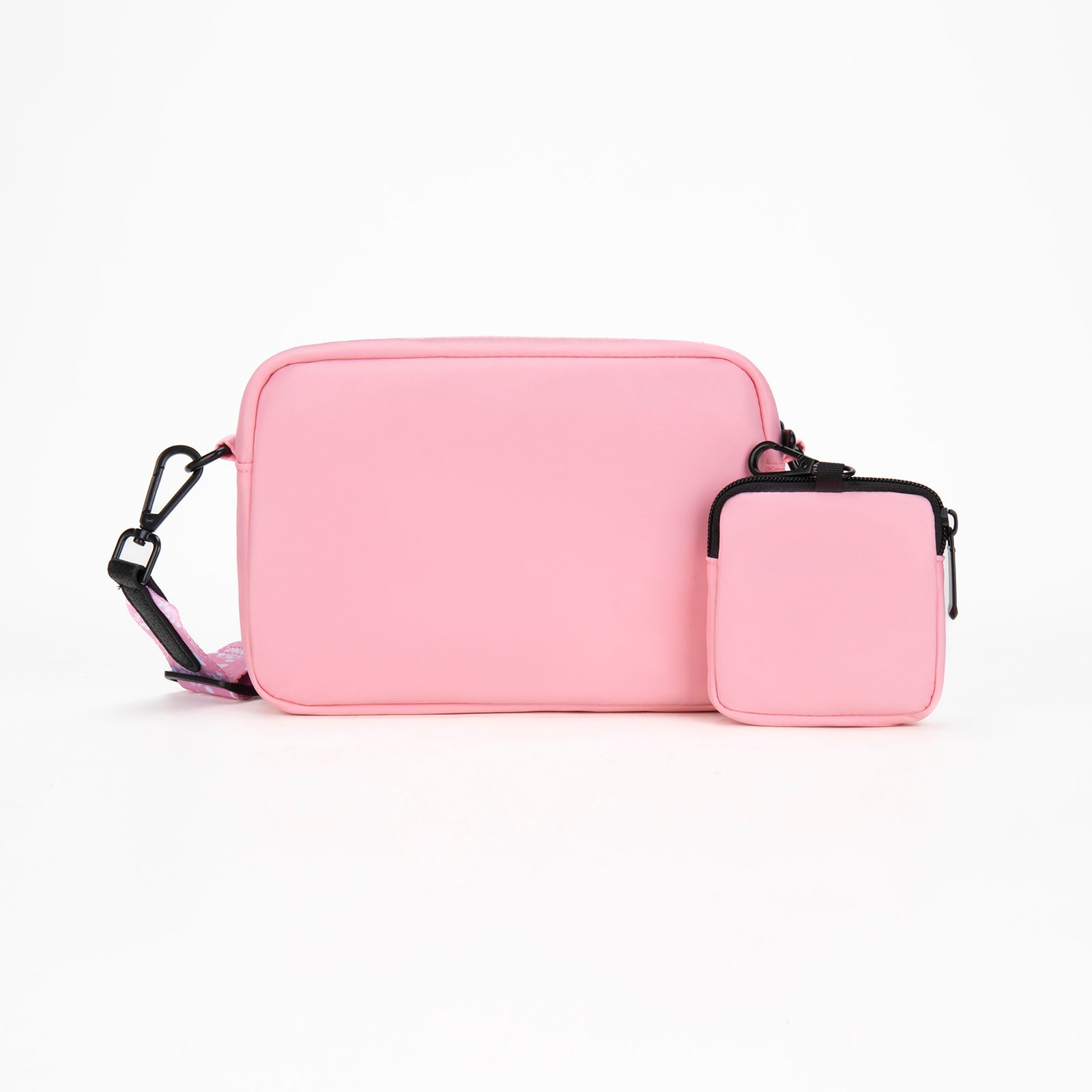 Pink crossbody bag with a smaller pouch on a white background