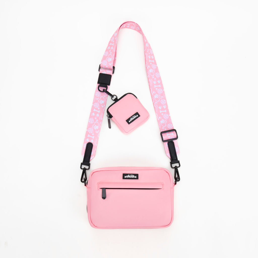 Pink crossbody bag with a matching pouch on a white background