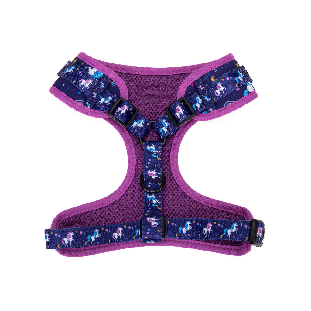 Purple dog harness with unicorn pattern on a white background