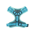 Dog harness with teal pattern on a white background