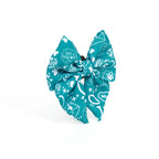 Teal bow with white patterns on a white background